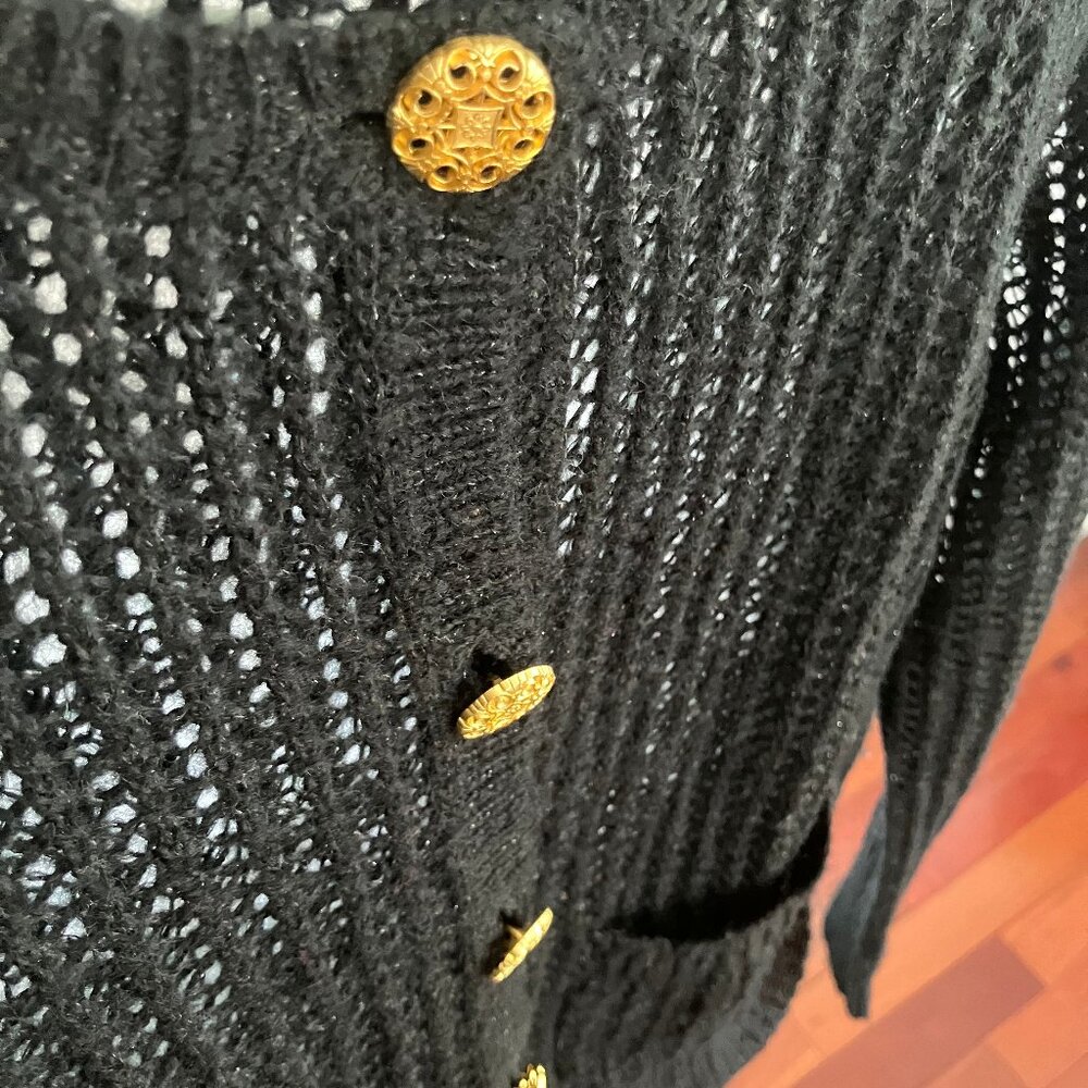Black crochet cropped cardigan with shimmer detail and bold gold buttons